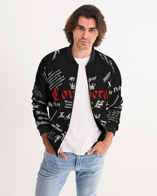 mens bomber jacket it is black with white lettering all over the front and back. It is a Christian Jacket it has scriptures all over it Across the chest it reads "Covered" in red and in the back is a red cross with the works "by the blood" in black over the horizontal bar of the cross the hem, cuffs, collar and zipper seam are black. it has pockets on the lower front of the jacket